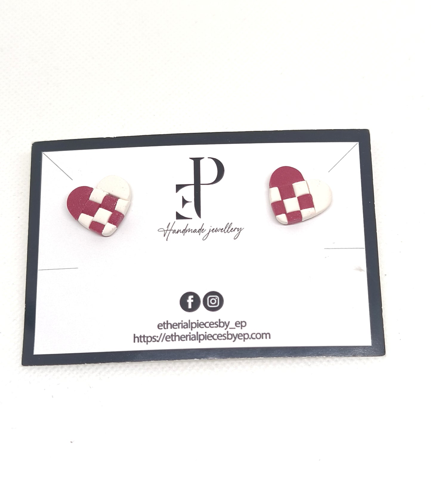 Handmade red and white Julehjerter earrings in polymer clay — with silver stainless-steel studs, displayed on branded jewellery ca