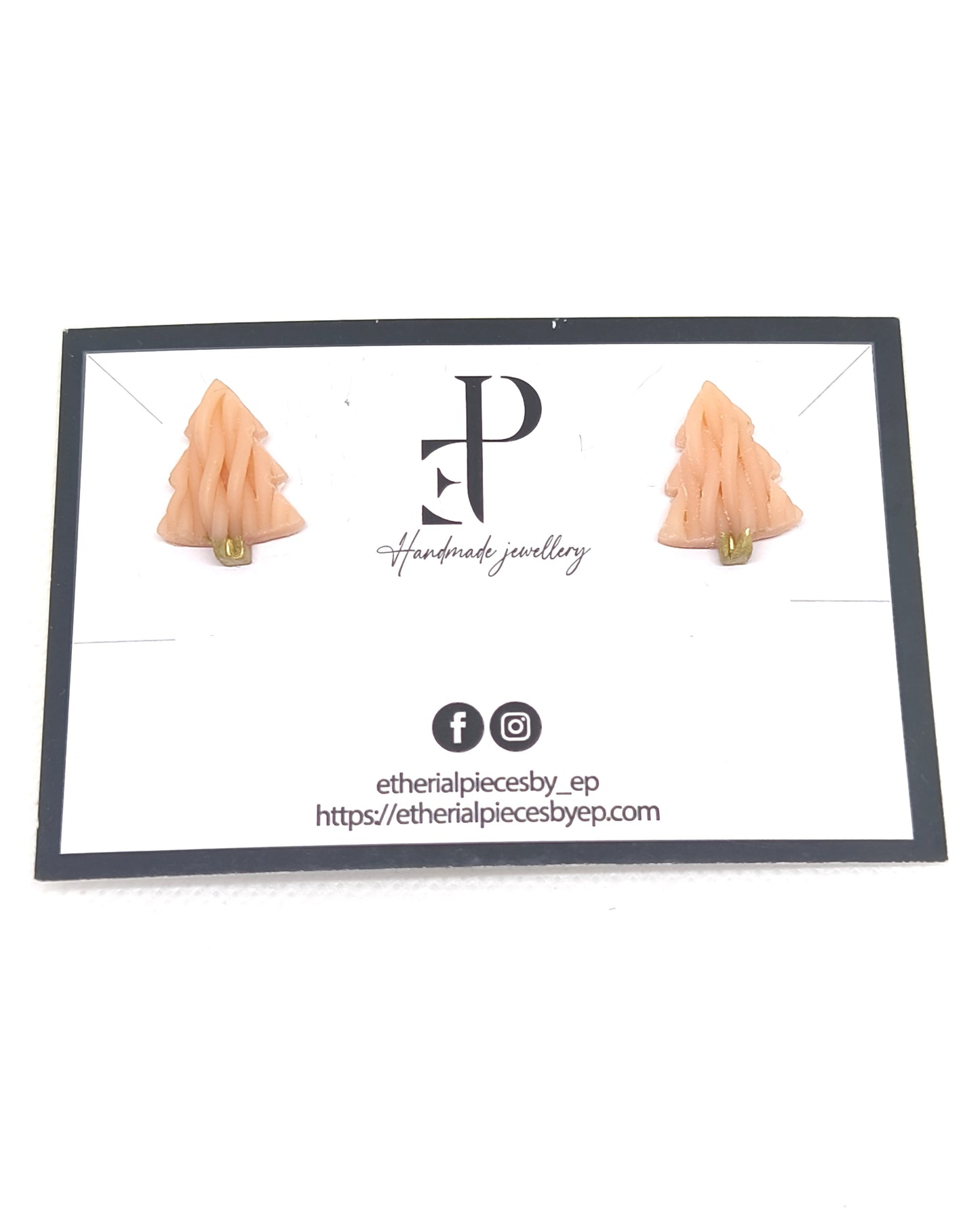 Handmade knitted-texture Christmas tree stud earrings with gold detail on jewelry card.