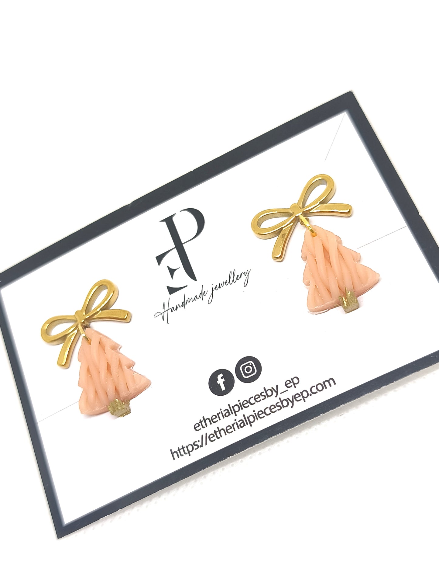 “Knitted-texture Christmas tree earrings with 18k gold-plated bow studs on jewelry card.”