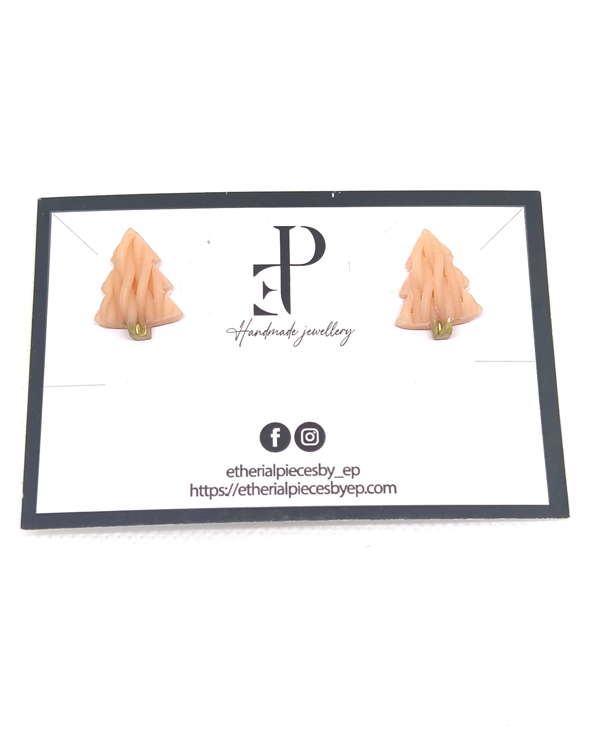 Handmade knitted-texture Christmas tree stud earrings with gold detail on jewelry card.